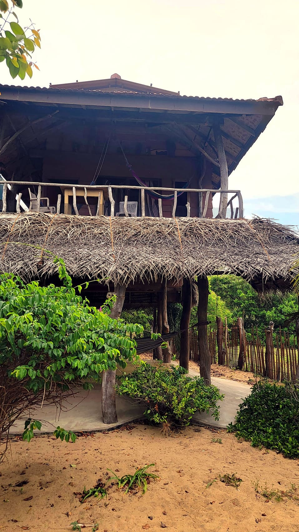 Two-storey thatched cabana among trees