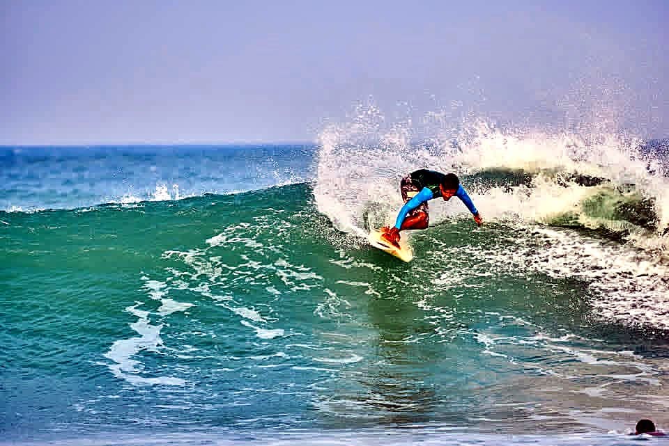 A surfer carving a turn at Arugam Bay